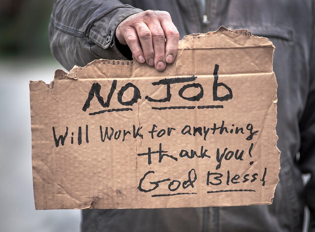 Man holding handwritten cardboard sign, No Job, Will Work, jobless, unemployed, coronavirus, employment, loss jobs, hope, charity, giving, desperate, fired, laidoff, help, economy broke. Homeless person holding sign looking for work.
