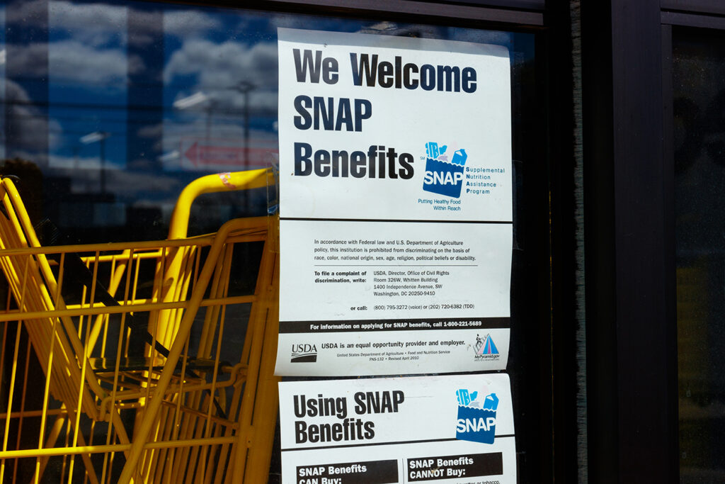 We Welcome SNAP Benefits Sign on Storefront Door.
