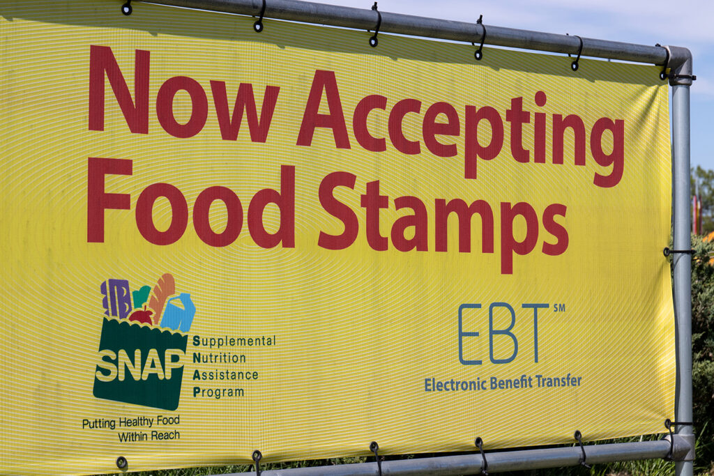 SNAP and EBT Accepted here sign. SNAP and Food Stamps provide nutrition benefits to supplement the budgets of disadvantaged families.