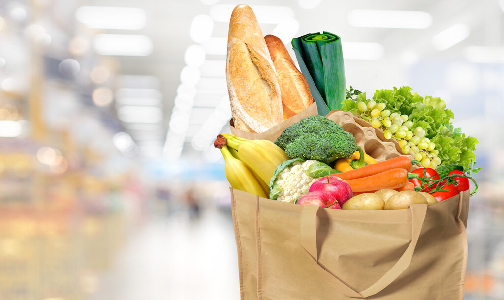 Food delivery Eco-friendly reusable shopping bag filled with different fruits, vegetables and bread.